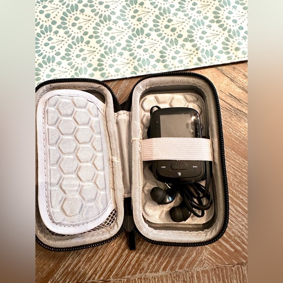 San disk MP3 player and case. Great condition except clip broke on back